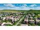 Expansive aerial view showcasing a neighborhood surrounded by rolling hills and a clear blue sky at 10328 Bluffmont Dr, Lone Tree, CO 80124