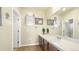 Bathroom with a large mirror, dual lighting, and a dark wood vanity at 10328 Bluffmont Dr, Lone Tree, CO 80124