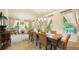 Elegant dining room featuring a large table, chandelier, and natural light from the multiple windows at 10328 Bluffmont Dr, Lone Tree, CO 80124