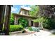 Charming two-story home with a stone facade, arched entryway, and professionally landscaped front yard at 10328 Bluffmont Dr, Lone Tree, CO 80124
