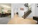 Welcoming foyer with hardwood floors, staircase, and views into dining and living spaces at 10328 Bluffmont Dr, Lone Tree, CO 80124