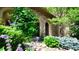 Charming home entrance with stone facade, lush greenery, and vibrant flowers. Great curb appeal! at 10328 Bluffmont Dr, Lone Tree, CO 80124