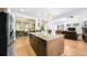 Spacious kitchen island with granite countertops and seamlessly blending into the dining and living areas at 10328 Bluffmont Dr, Lone Tree, CO 80124