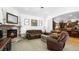 Spacious living room with a brick fireplace, plush seating, and an open view to the kitchen at 10328 Bluffmont Dr, Lone Tree, CO 80124