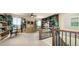 Open loft area featuring built-in shelving, desk, and large windows providing natural light at 10328 Bluffmont Dr, Lone Tree, CO 80124