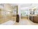 Luxurious main bathroom featuring a glass shower, soaking tub, and dual vanities at 10328 Bluffmont Dr, Lone Tree, CO 80124