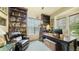 Comfortable home office featuring custom bookcases and a stately executive desk at 10328 Bluffmont Dr, Lone Tree, CO 80124