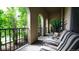 Inviting outdoor porch with cushioned seating, stylish railings, and views of lush greenery at 10328 Bluffmont Dr, Lone Tree, CO 80124