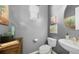 Stylish powder room with modern fixtures, vanity, and decorative artwork at 10328 Bluffmont Dr, Lone Tree, CO 80124
