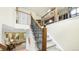 Carpeted staircase with decorative wrought iron bannister and wood trim leads to the upper level of the house at 10328 Bluffmont Dr, Lone Tree, CO 80124