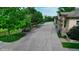 Long driveway leading to a residence, framed by mature trees and manicured greenery at 10328 Bluffmont Dr, Lone Tree, CO 80124