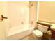 Bathroom featuring tiled shower-tub, neutral walls and a toilet at 1870 S Pitkin Cir # B, Aurora, CO 80017