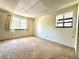 Well-lit bedroom with large windows showcasing natural light and neutral carpet at 1870 S Pitkin Cir # B, Aurora, CO 80017