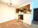 Dining area with a chandelier and pass-through to the kitchen, carpeted floor and neutral walls at 1870 S Pitkin Cir # B, Aurora, CO 80017