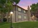 Exterior view of home with brown siding, a stone chimney, and manicured lawn at 1870 S Pitkin Cir # B, Aurora, CO 80017