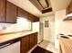 Kitchen with wood cabinets, white appliances and double sink at 1870 S Pitkin Cir # B, Aurora, CO 80017