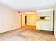Open-concept living area with carpet, view into the kitchen and a chandelier in the dining area at 1870 S Pitkin Cir # B, Aurora, CO 80017