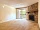 Living room with a stone fireplace, carpet flooring, and sliding glass doors to a balcony at 1870 S Pitkin Cir # B, Aurora, CO 80017
