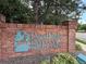 Brick sign with 'Deer Pointe Brittany Highlands' in teal lettering, surrounded by greenery at 1870 S Pitkin Cir # B, Aurora, CO 80017