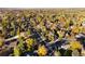 An aerial view showcases the property's location in a neighborhood surrounded by colorful fall foliage at 2395 W Davies Ave, Littleton, CO 80120