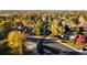 Scenic aerial view showcases the neighborhood's lush greenery and charming homes in a serene, tree-filled environment at 2395 W Davies Ave, Littleton, CO 80120