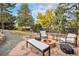 Inviting backyard features a stone fire pit, seating, and lush greenery, great for outdoor gatherings at 2395 W Davies Ave, Littleton, CO 80120