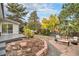 Relaxing backyard features a patio, firepit, and mature trees, perfect for outdoor enjoyment at 2395 W Davies Ave, Littleton, CO 80120