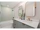 Bright bathroom featuring double sinks, modern fixtures, and a shower-tub combination at 2395 W Davies Ave, Littleton, CO 80120