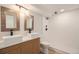 Modern bathroom featuring dual vessel sinks, wood-style vanity, and a sleek walk-in shower at 2395 W Davies Ave, Littleton, CO 80120