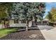 Charming single-story home with a large tree in the front yard and well-maintained landscaping at 2395 W Davies Ave, Littleton, CO 80120