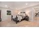 This main bedroom features soft lighting, views of the outdoors, and an ensuite bathroom at 2395 W Davies Ave, Littleton, CO 80120