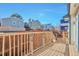 Private backyard deck with wooden railings, perfect for outdoor dining and relaxing with neighborhood views at 479 W Jamison Cir, Littleton, CO 80120