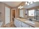 Well-lit bathroom with double sinks, granite countertop, and a soaking tub at 479 W Jamison Cir, Littleton, CO 80120