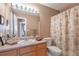 Standard bathroom featuring a vanity with countertop space, toilet and shower at 479 W Jamison Cir, Littleton, CO 80120