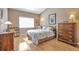 Spacious bedroom featuring a large window and hardwood floors at 479 W Jamison Cir, Littleton, CO 80120