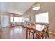 Bright living room featuring a dining area, gleaming wood floors, and large windows at 479 W Jamison Cir, Littleton, CO 80120