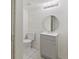 Well-lit bathroom includes a vanity with storage and a toilet, creating a functional and clean space at 9044 E Nassau Ave, Denver, CO 80237