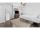 Bright bedroom features a ceiling fan, tv and modern wood furniture at 9044 E Nassau Ave, Denver, CO 80237