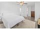 Bright bedroom features a ceiling fan and a full-size bed at 9044 E Nassau Ave, Denver, CO 80237