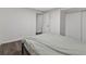 Cozy bedroom featuring wood floors, a comfortable bed, and a closet for ample storage at 9044 E Nassau Ave, Denver, CO 80237