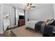 This bright bedroom includes wood floors, a ceiling fan, natural light, and a stylish dresser at 9044 E Nassau Ave, Denver, CO 80237