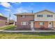 Charming two-story home with brick and siding, green lawn, and blue skies at 9044 E Nassau Ave, Denver, CO 80237