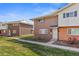 Exterior view of a two story brick home with a well maintained lawn and landscaping at 9044 E Nassau Ave, Denver, CO 80237