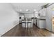 Bright kitchen with white cabinets, stainless steel appliances, and a convenient breakfast bar at 9044 E Nassau Ave, Denver, CO 80237