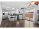 Open kitchen with stainless appliances, breakfast bar, and sliding glass door to the backyard at 9044 E Nassau Ave, Denver, CO 80237