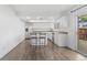 Bright kitchen features an island with breakfast bar and stainless steel appliances at 9044 E Nassau Ave, Denver, CO 80237