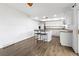 Bright kitchen features an island with breakfast bar and stainless steel appliances at 9044 E Nassau Ave, Denver, CO 80237