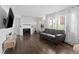 Inviting living room showcasing dark wood floors, neutral walls, and comfortable seating at 9044 E Nassau Ave, Denver, CO 80237
