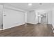 Spacious living room features modern floors and a large mirror, perfect for entertaining and relaxing at 9044 E Nassau Ave, Denver, CO 80237