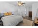 Bright main bedroom features wood floors, a ceiling fan, a walk-in closet, and a door to the main bathroom at 9044 E Nassau Ave, Denver, CO 80237